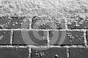 Snow on urban pavement in black and white