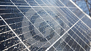 Snow and water drops on the solar panel. Precipitation reduces the generation of electricity from solar cells