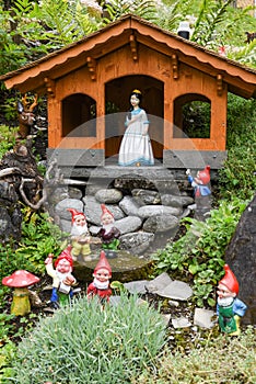 Snow White and Dwarfs on a garden of a house photo