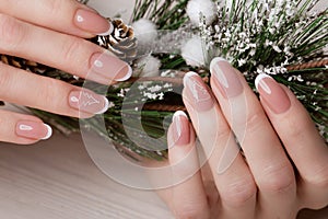 Snow White manicure on female hands. Winter nail design.