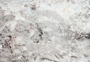 Snow-white marble, polished surface of natural stone with fine veins and black blotches