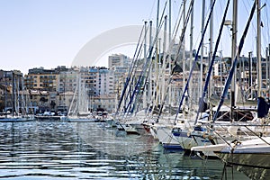 Snow-white sailing yachts in a marina in Marseille on a bright sunny day. Beautiful view