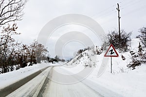 Snow winter road and Z warning road sign