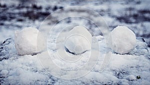 Snowballs on a snow-covered table, winter fun