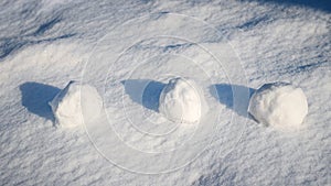 Snowballs in the snow in sunny weather, winter fun