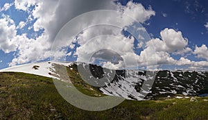 Snowbanks underlieing on the mountainside in Altay mountains