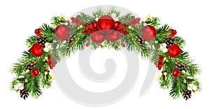 Snowberries with green twigs of Christmas tree, red decorations and cones in a holiday wave garland isolated on white background