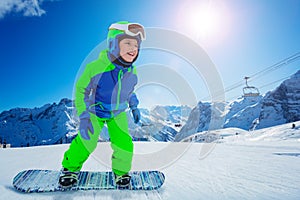 Snowboard boy move fast on the ski resort hill