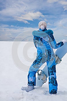 Snowboard girl in blue stay at the bottom of hill