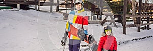 Snowboard instructor teaches a boy to snowboarding. Activities for children in winter. Children`s winter sport