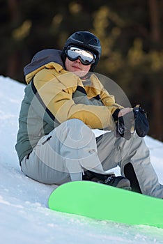 Snowboard man sits