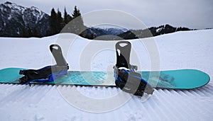 Snowboard on ski piste in winter