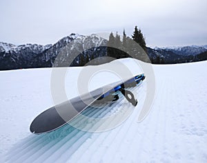 Snowboard on ski piste in winter