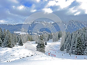 Snowboard and ski trails or alpine trails for winter sports above the tourist resort of Lenzerheide