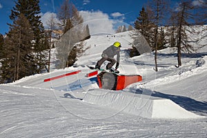 Snowboarder in Action: Jumping in the Mountain Snowpark