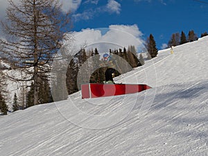 Snowboarder in Action: Jumping in the Mountain Snowpark