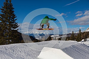 Snowboarder in Action: Jumping in the Mountain Snowpark