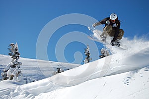 Snowboarder in action on a sunny winter day.