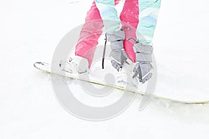 Snowboarder adjusting bindings