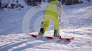 Snowboarder on board jumping on snowy slope