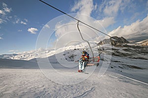 Snowboarder climbing up the hill