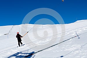 Snowboarder climbs the ski lift