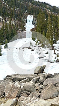 Snowboarder descends a snowy mountain slope