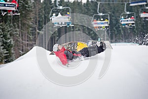 Snowboarder falls on the slopes during the jumping