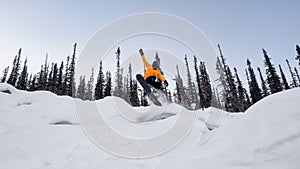 A snowboarder flies, jumping on the trampoline winter snow