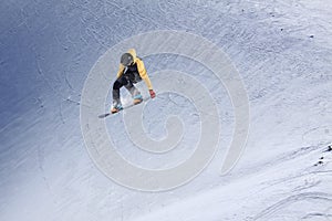 Snowboarder flying on the background of snowy slope. Extreme winter sports, snowboarding.