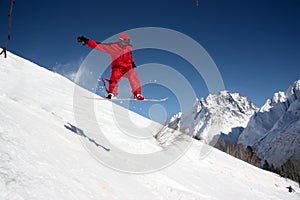 Snowboarder Flying In The Mountains