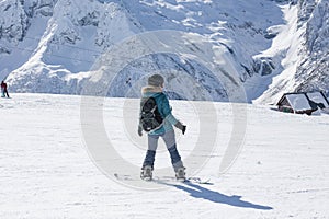 Snowboarder girl in the mountains.