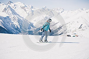 Snowboarder girl in the mountains.