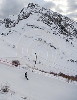 Snowboarder go downhill at the Krasnaya Polyana ski resort
