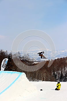 Snowboarder going off a big jump in hanazono park