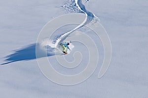 Snowboarder having fun in deep backcountry snow