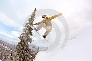 Snowboarder jump offpiste forest freeride
