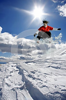 snowboarder jumping against blue sky