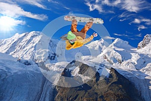 Snowboarder jumping against blue sky