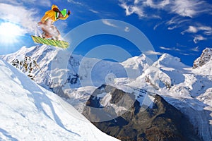 Snowboarder jumping against blue sky