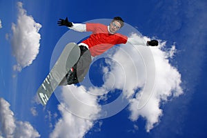 Snowboarder jumping against sky