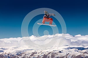 Snowboarder jumping in air