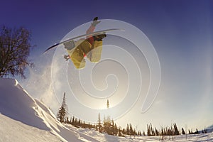Snowboarder jumping through air with deep blue sky in background