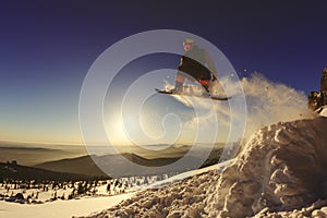 Snowboarder jumping through air with deep blue sky in background