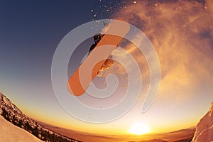 Snowboarder jumping through air with deep blue sky in background