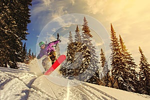 Snowboarder jumping through air with deep blue sky in background