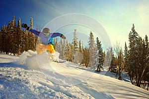 Snowboarder jumping through air with deep blue sky in background