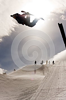 Snowboarder Jumping in Halfpipe