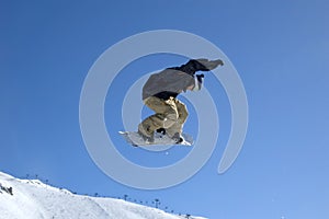 Snowboarder jumping high in the air