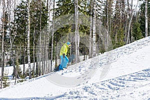 Snowboarder jumping in the mountains on a forest background